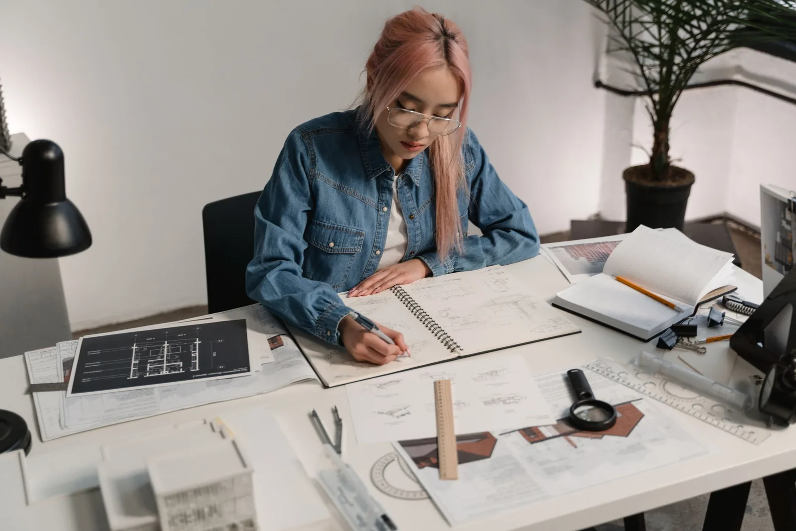 A drawing desk by a bright window
