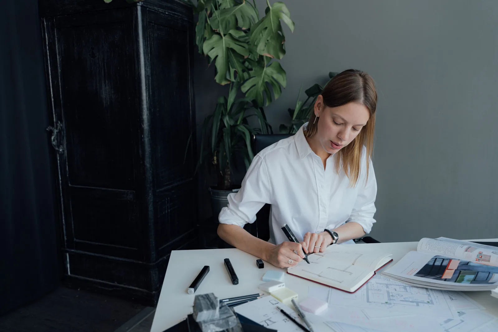 Marisol Aranda sketching at a white desk