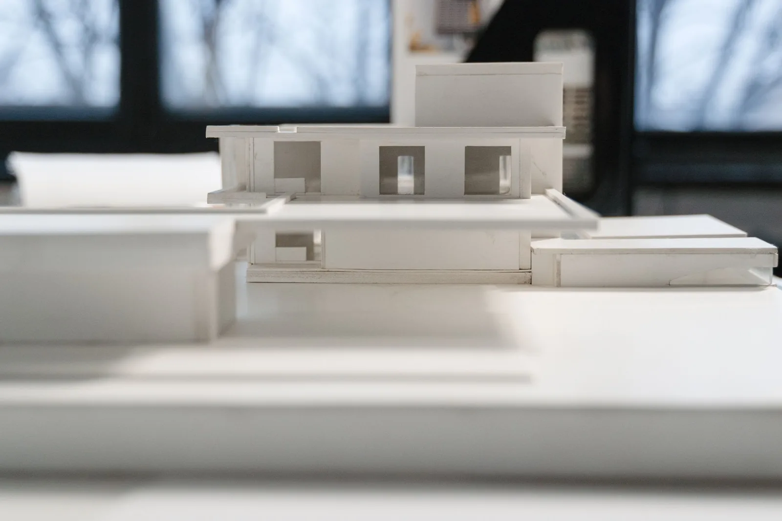 A white card model on a table