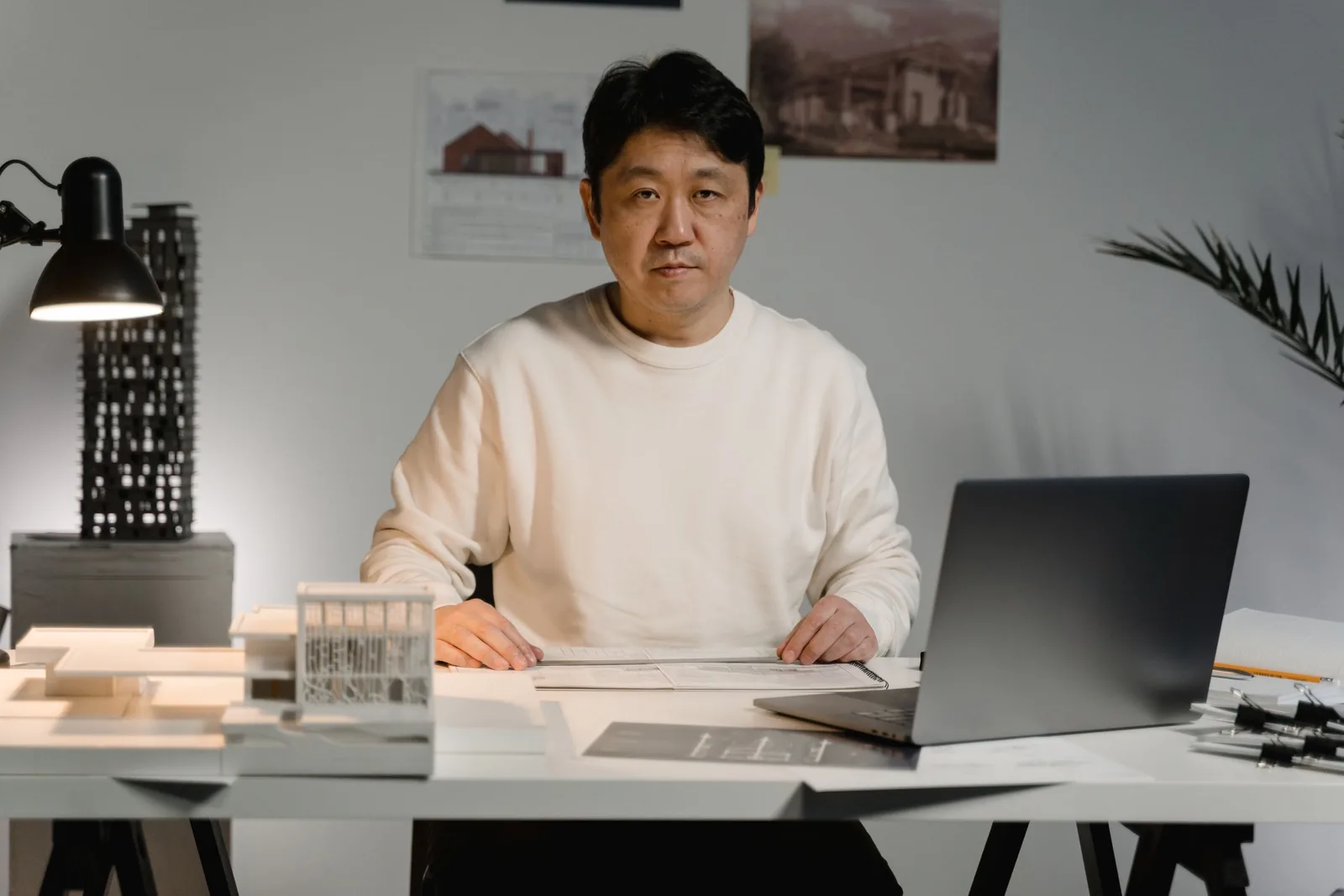 Teo Lindqvist at his desk with a card model